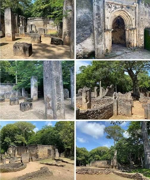 A traveler standing beneath a carved stone archway at the Gede Ruins near Malindi