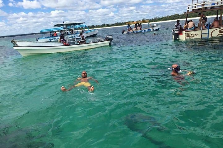 A fleet of tour boats anchored in the turquoise waters off Watamu