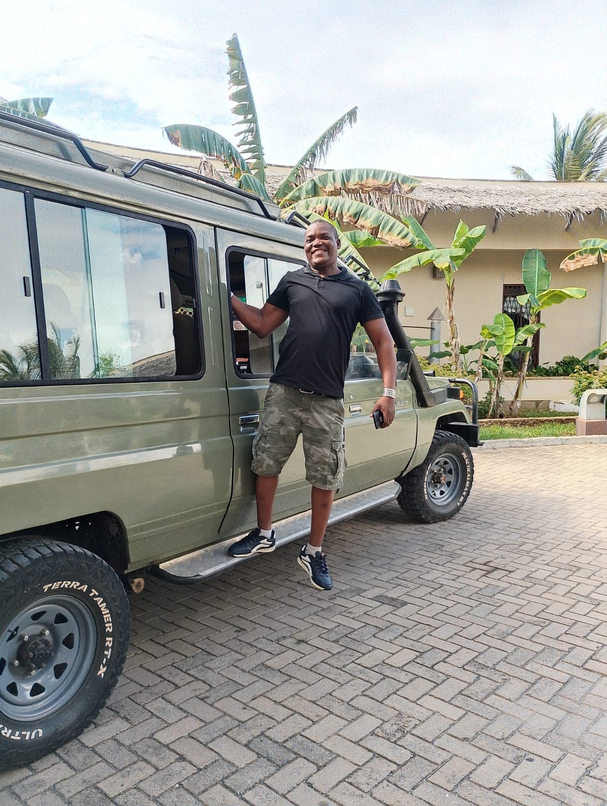 Alfonze Kazungu stepping down from his safari vehicle outside a coastal lodge